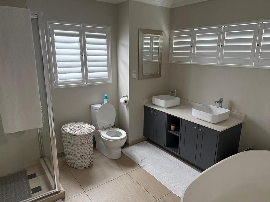 Bathroom with double vanity and bathtub