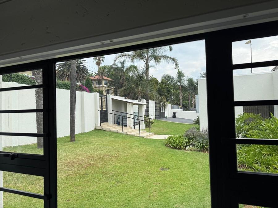 View across the palm-lined Hillside Enclosure garden